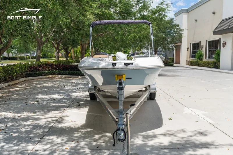 Slide: The Image of 2021 Hurricane SS 205 boat on trailer, parked outdoors near trees and buildings. - 5