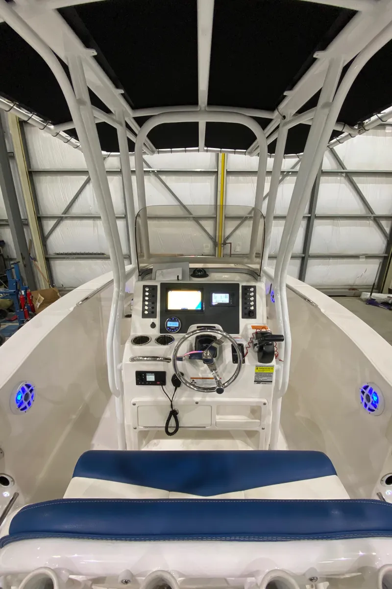 Slide: The Image of 2022 Robalo R200 Center Console boat interior with modern dashboard and seating. - 11