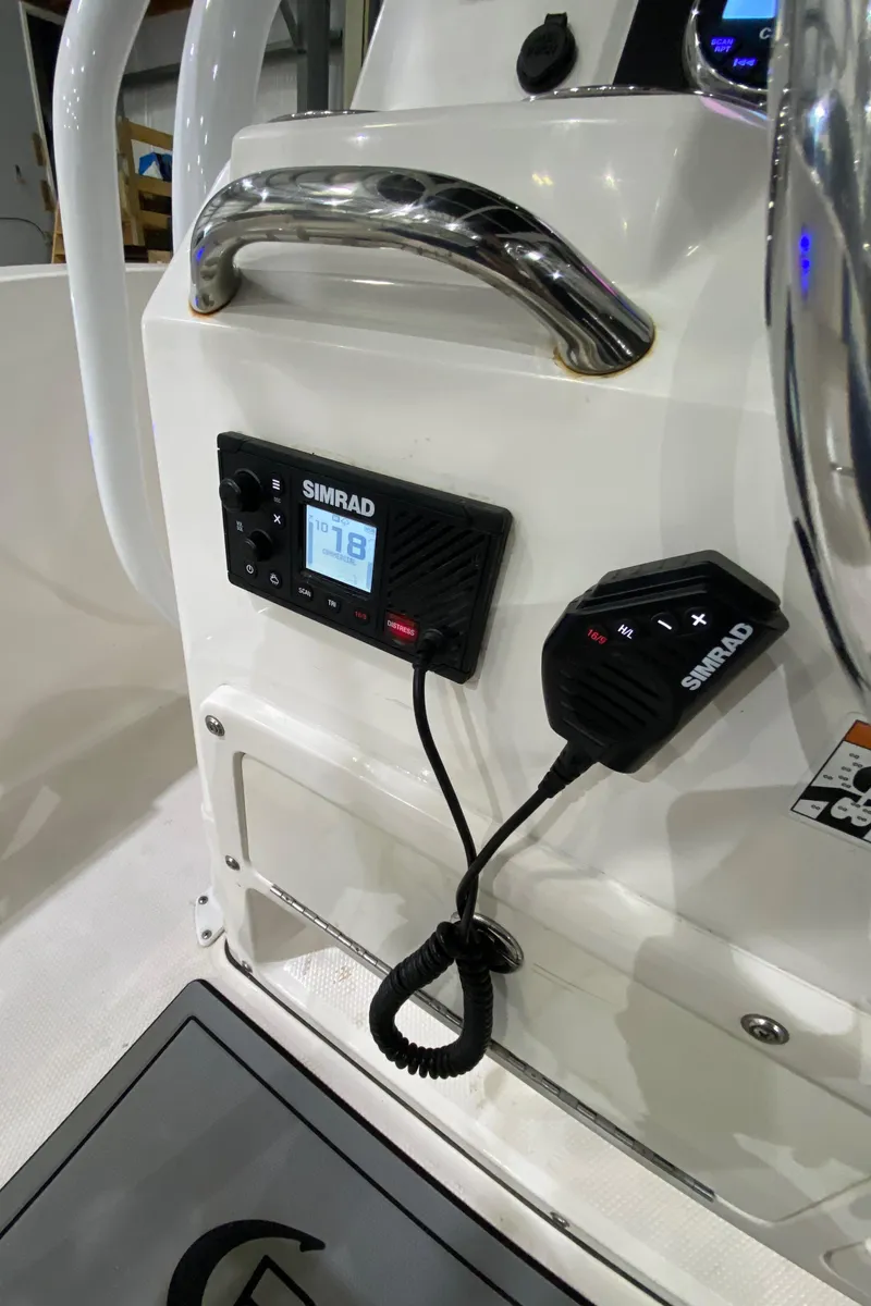 Slide: The Image of 2022 Robalo R200 Center Console with Simrad marine electronics display. - 13