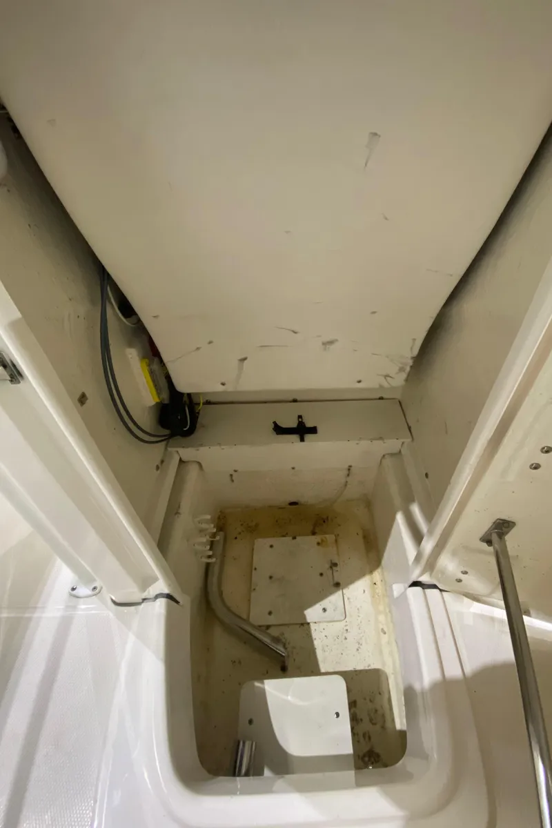 Slide: The Image of 2022 Robalo R200 Center Console storage compartment, showcasing interior space and utility features. - 18