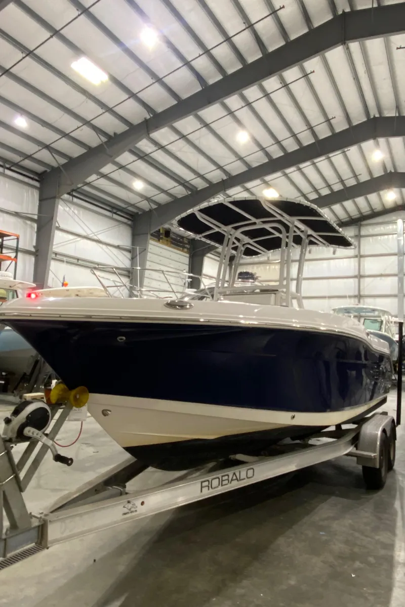Slide: The Image of 2022 Robalo R200 Center Console boat on trailer in indoor storage facility. - 4