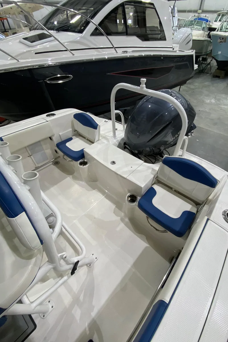 Slide: The Image of 2022 Robalo R200 Center Console boat interior with seating and engine view. - 8