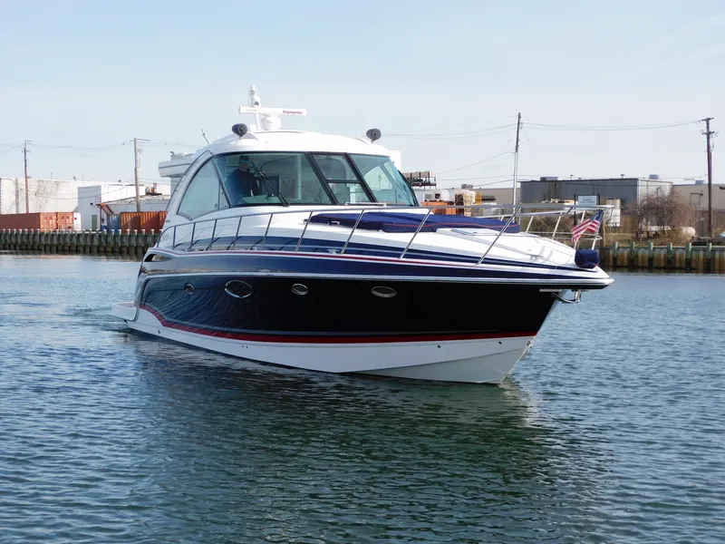 Slide: The Image of 2015 Formula YACHT 45 cruising in a calm harbor, showcasing sleek design and luxury. - 1
