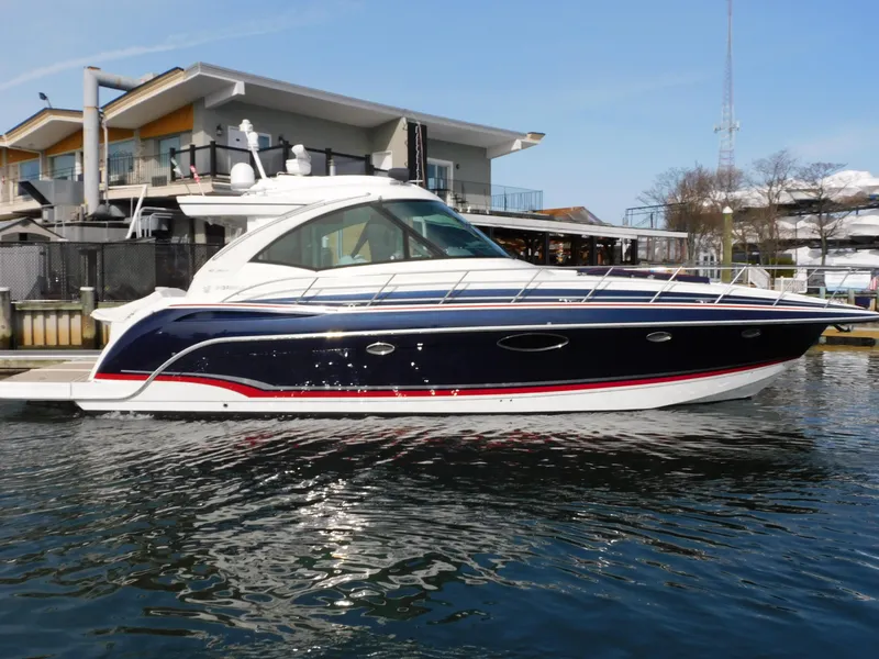 Slide: The Image of 2015 Formula YACHT 45 docked at marina, sleek design, blue and white exterior. - 12
