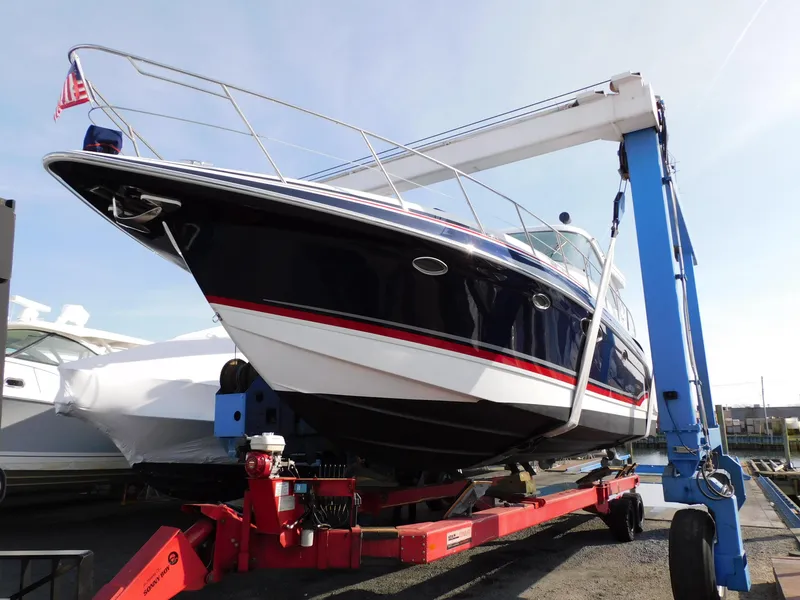 Slide: The Image of 2015 Formula YACHT 45 on a lift, showcasing sleek design and American flag. - 13
