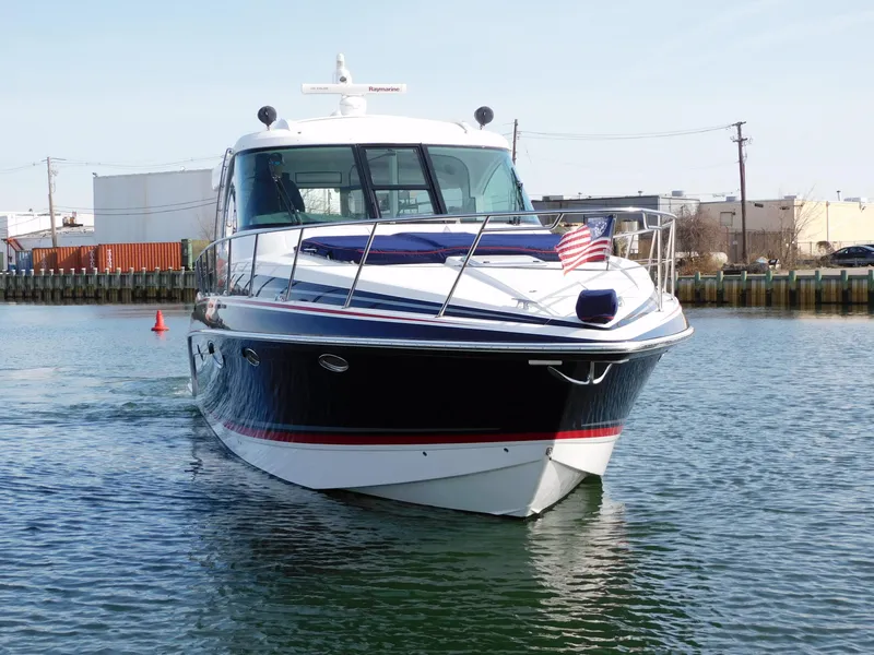 Slide: The Image of 2015 Formula YACHT 45 cruising in a harbor, displaying an American flag. - 2