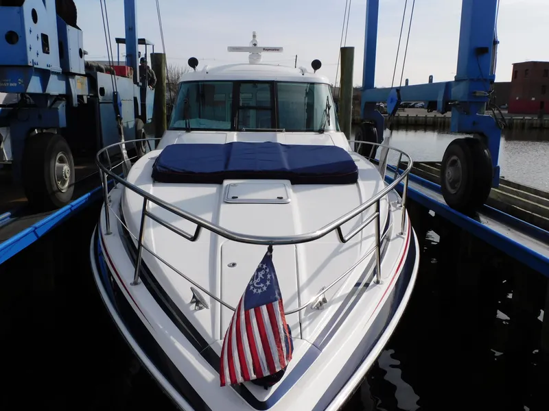 Slide: The Image of 2015 Formula YACHT 45 docked, featuring sleek design and American flag. - 34