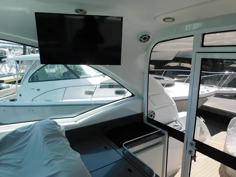 Slide: The Image of Interior view of 2015 Formula YACHT 45 with TV and docked boats outside. - 38