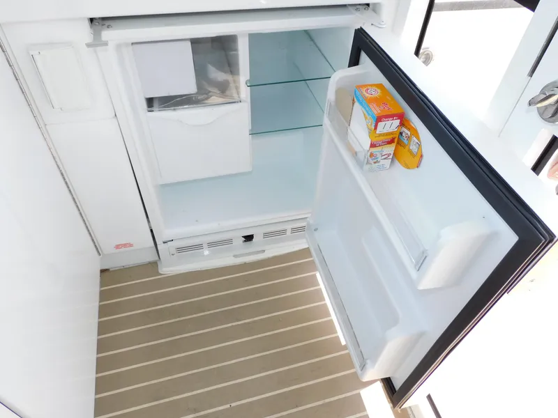 Slide: The Image of Open refrigerator on Formula YACHT 45, 2015 model, with baking soda and cheese inside. - 46
