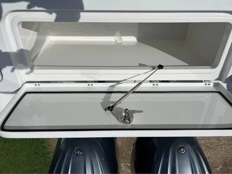 Slide: The Image of 2022 Sea Hunt Gamefish 27 storage compartment with open lid and hydraulic support. - 12