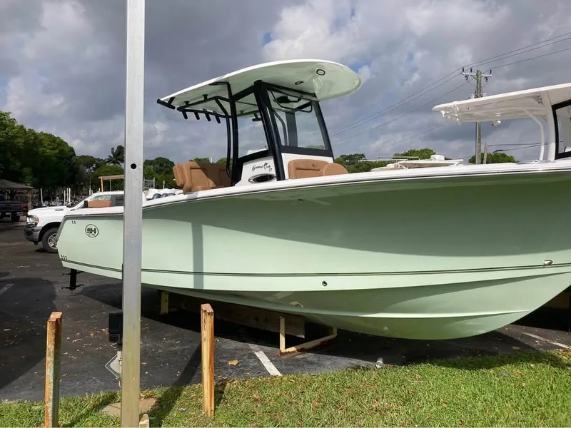 Slide: The Image of 2022 Sea Hunt Gamefish 27 boat in a parking lot, under cloudy skies. - 3