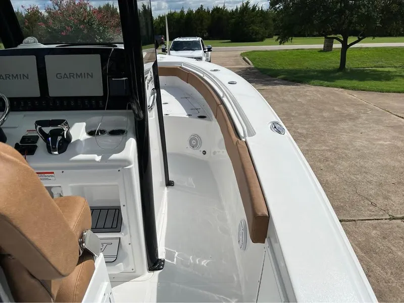 Slide: The Image of 2022 Sea Hunt Gamefish 27 boat with Garmin navigation, parked on a driveway. - 9