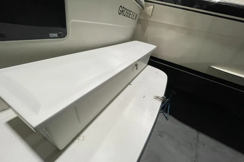 Slide: The Image of 1995 Carver 440 Aft Cabin Motor Yacht, white exterior detail, docked indoors. - 11
