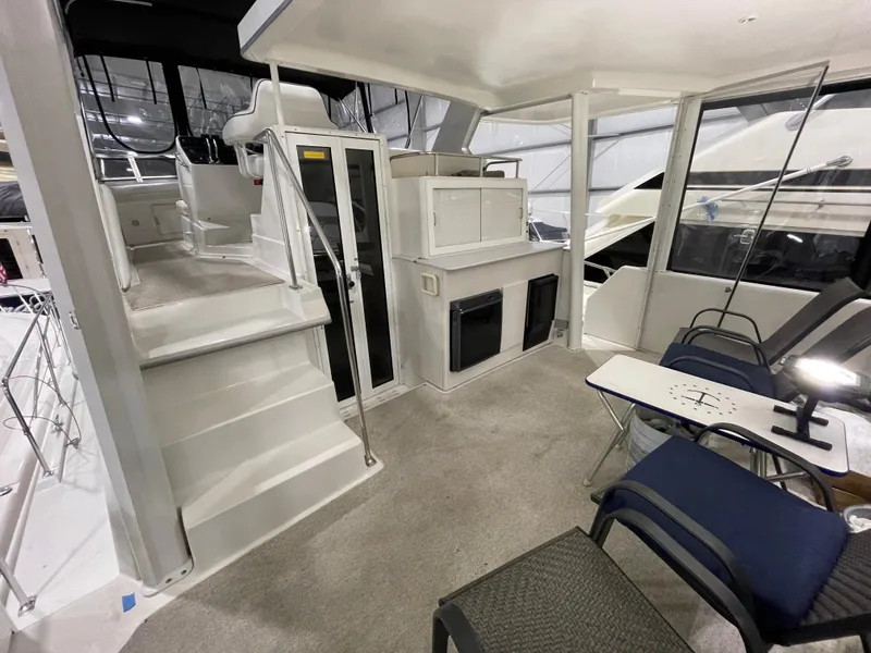 Slide: The Image of 1995 Carver 440 Aft Cabin Motor Yacht interior with seating and stairs. - 12