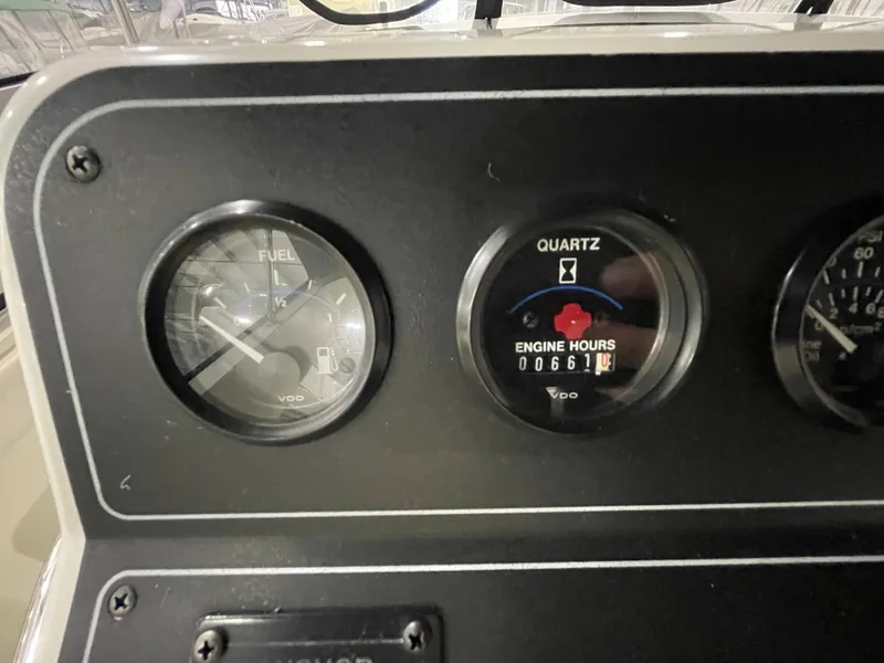Slide: The Image of 1995 Carver 440 Aft Cabin Motor Yacht dashboard with fuel and engine hour gauges. - 19