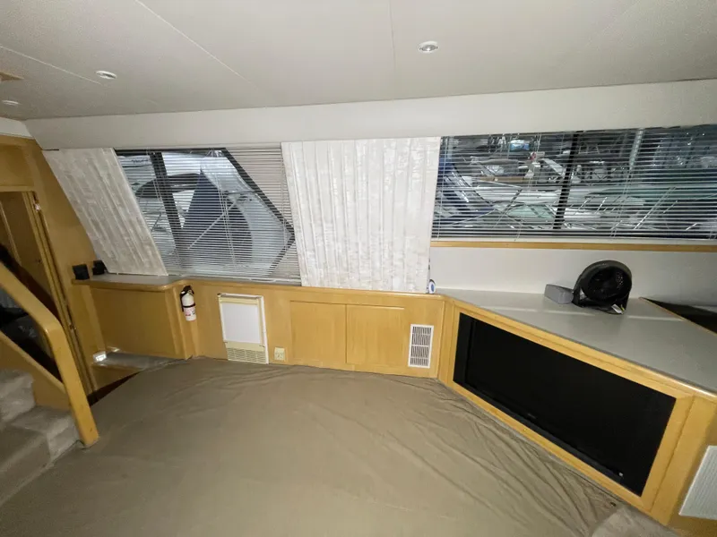 Slide: The Image of 1995 Carver 440 Aft Cabin Motor Yacht interior with large windows and modern furnishings. - 26