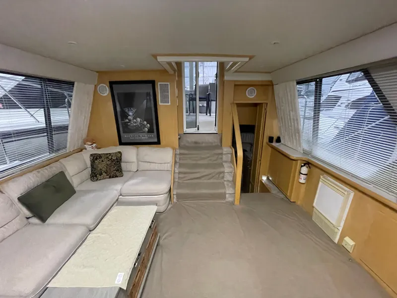 Slide: The Image of Interior of 1995 Carver 440 Aft Cabin Motor Yacht with cozy seating and large windows. - 28