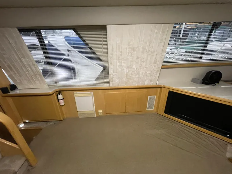 Slide: The Image of Interior of 1995 Carver 440 Aft Cabin Motor Yacht with large windows and beige decor. - 29