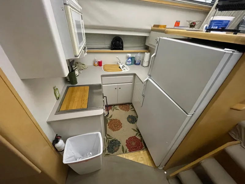 Slide: The Image of 1995 Carver 440 Aft Cabin Motor Yacht kitchen with appliances and storage. - 34