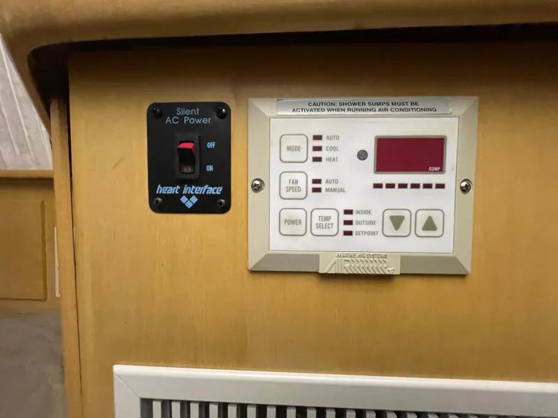 Slide: The Image of Control panel on a 1995 Carver 440 Aft Cabin Motor Yacht, featuring AC power and climate settings. - 39