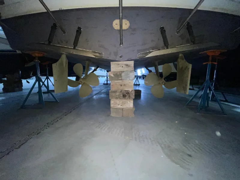 Slide: The Image of 1995 Carver 440 Aft Cabin Motor Yacht on stands, showing propellers and rudders. - 4