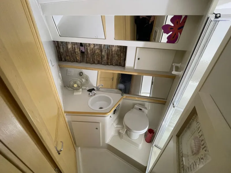 Slide: The Image of 1995 Carver 440 Aft Cabin Motor Yacht bathroom with sink, toilet, and mirror. - 40