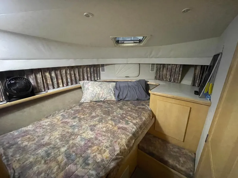 Slide: The Image of 1995 Carver 440 Aft Cabin Motor Yacht bedroom with cozy bed and storage. - 43