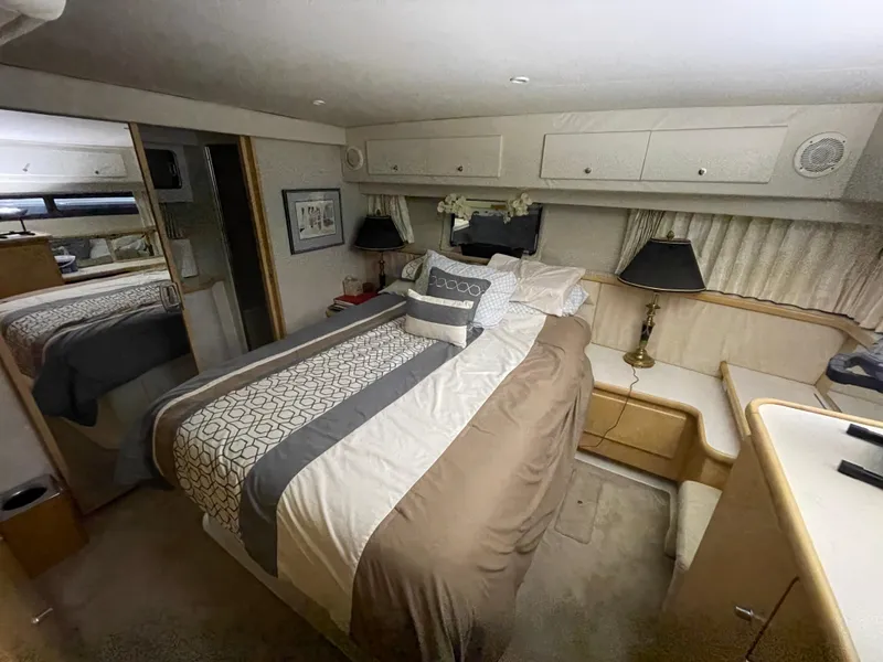 Slide: The Image of Luxurious bedroom in 1995 Carver 440 Aft Cabin Motor Yacht with elegant bedding and decor. - 46