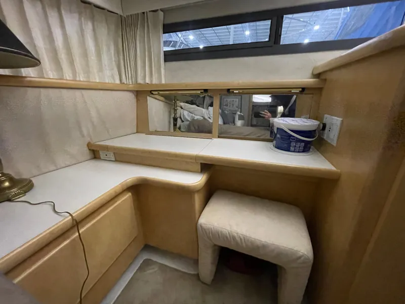 Slide: The Image of 1995 Carver 440 Aft Cabin Motor Yacht interior with vanity, stool, and mirror. - 47