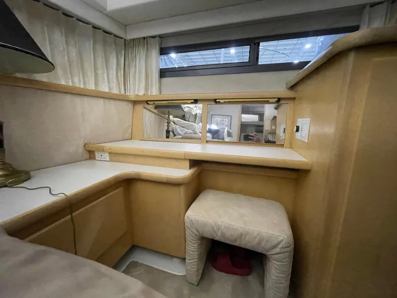 Slide: The Image of 1995 Carver 440 Aft Cabin Motor Yacht interior with vanity and stool. - 49