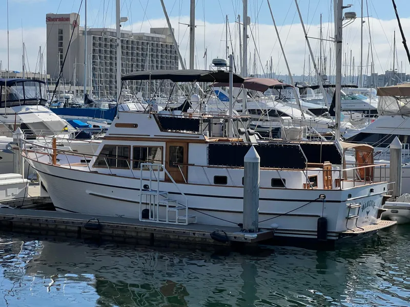 The Image of 1984 DeFever 41 Trawler docked at marina, surrounded by other boats. - 0
