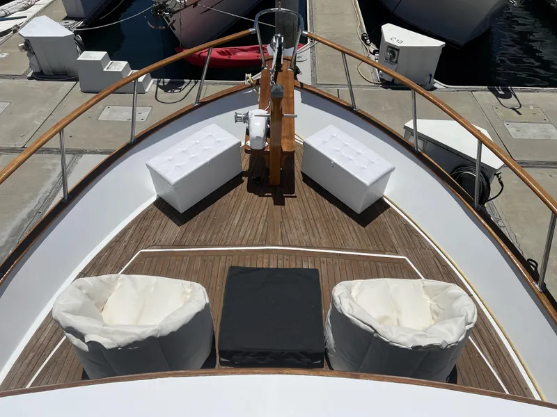 Slide: The Image of 1984 DeFever 41 Trawler bow with seating, docked at marina. - 11