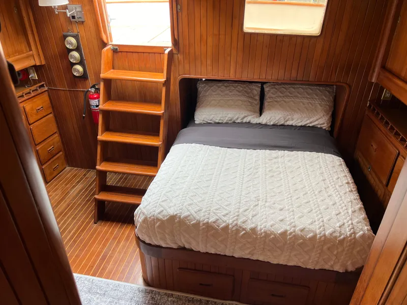 Slide: The Image of 1984 DeFever 41 Trawler cabin with wooden interior, bed, and stairs. - 15