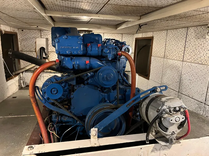Slide: The Image of Engine room of a 1984 DeFever 41 Trawler with visible blue machinery. - 26