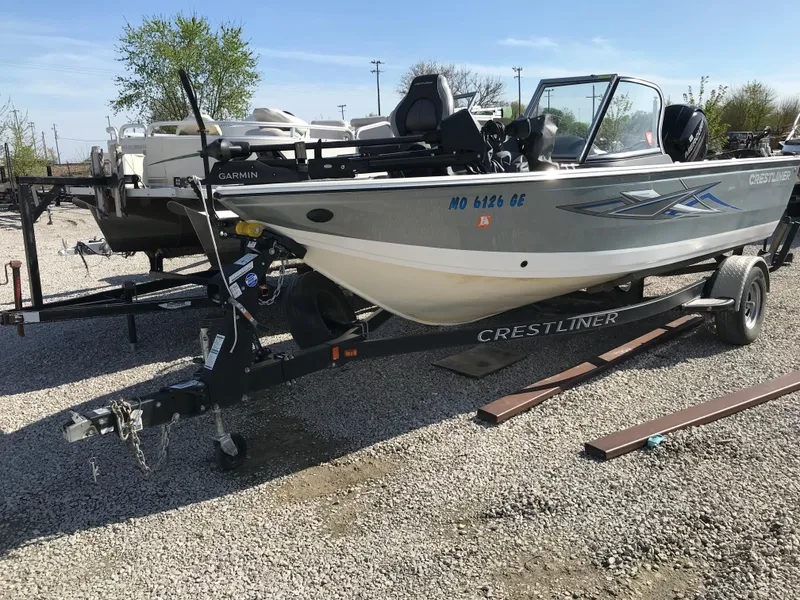 Slide: The Image of 2016 Crestliner 1850 Super Hawk boat on trailer, parked on gravel lot. - 1