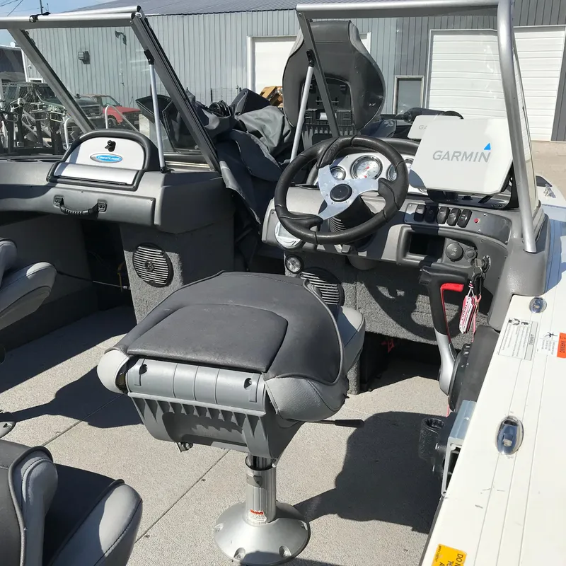 Slide: The Image of 2016 Crestliner 1850 Super Hawk boat interior with Garmin navigation system and seating. - 10