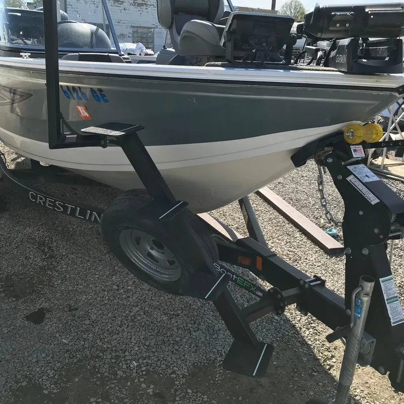 Slide: The Image of 2016 Crestliner 1850 Super Hawk boat on trailer, parked on gravel. - 12