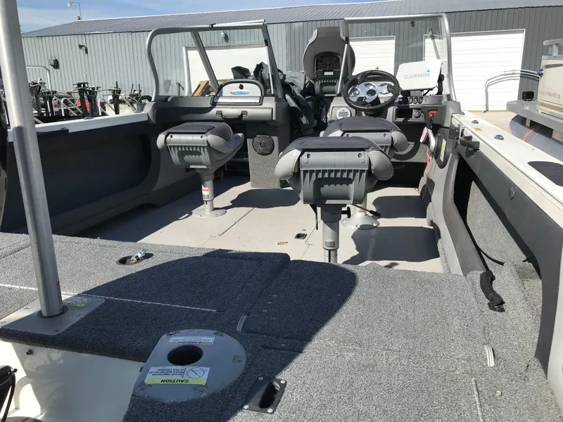 Slide: The Image of 2016 Crestliner 1850 Super Hawk interior with seating and dashboard, in a sunny outdoor setting. - 17