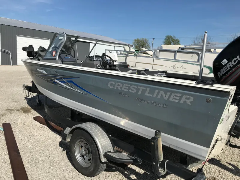 Slide: The Image of 2016 Crestliner 1850 Super Hawk boat on trailer, parked outdoors. - 2