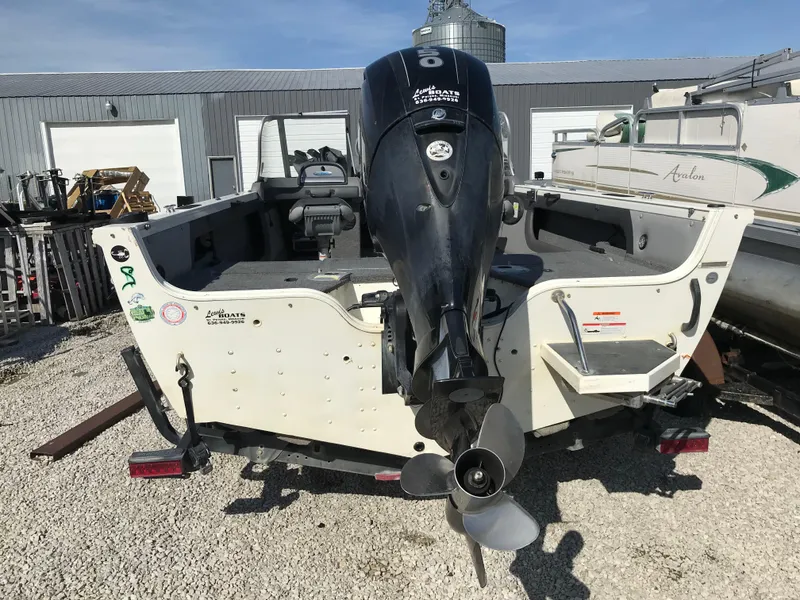 Slide: The Image of 2016 Crestliner 1850 Super Hawk boat with outboard motor, parked on gravel. - 4
