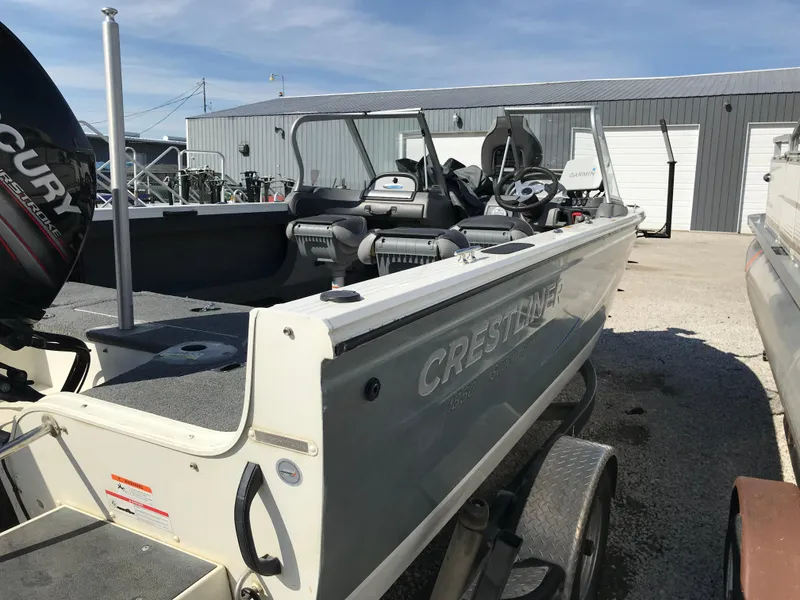 Slide: The Image of 2016 Crestliner 1850 Super Hawk boat on trailer, parked outdoors near a metal building. - 5