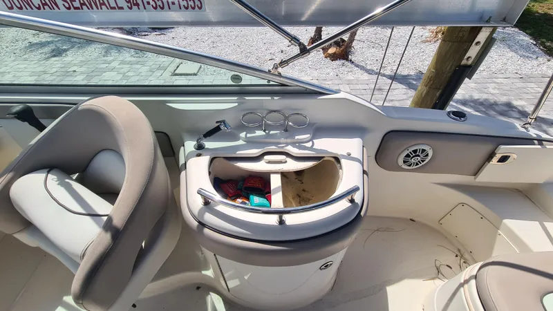 Slide: The Image of 2004 Sea Ray 270 Sundeck interior with seating and storage compartment. - 12
