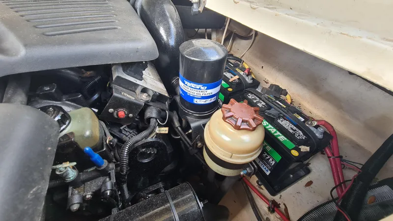 Slide: The Image of Engine compartment of a 2004 Sea Ray 270 Sundeck with visible batteries and components. - 19