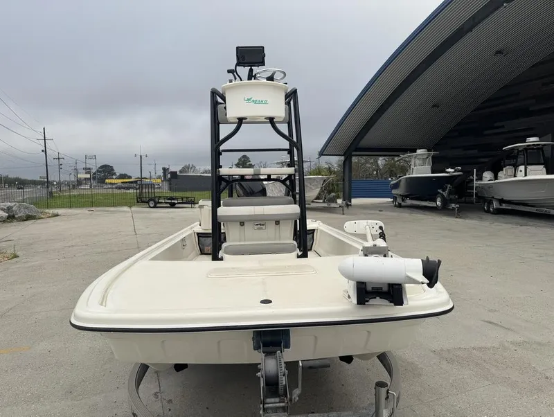 Slide: The Image of 2018 Mako Pro Skiff 19 CC Top Drive boat in outdoor storage area. - 10