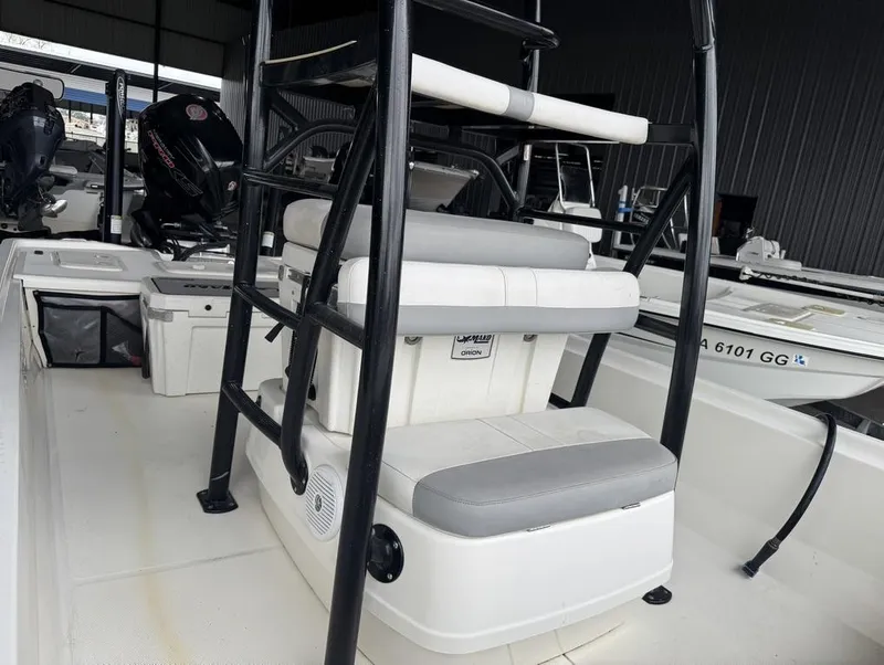 Slide: The Image of 2018 Mako Pro Skiff 19 CC Top Drive boat interior with seating and storage. - 11