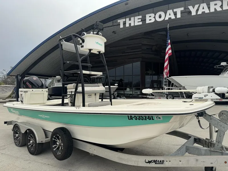 Slide: The Image of 2018 Mako Pro Skiff 19 CC Top Drive boat on trailer at dealership. - 2