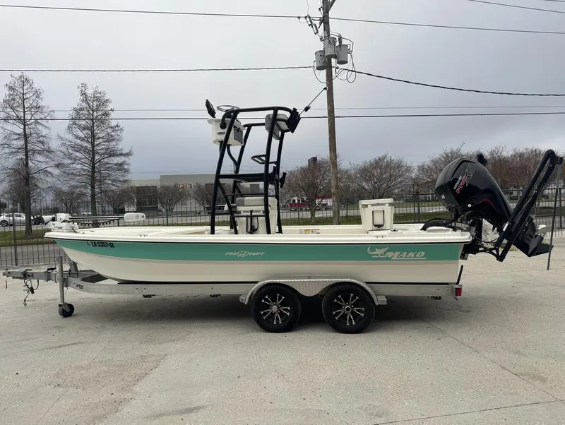 Slide: The Image of 2018 Mako Pro Skiff 19 CC Top Drive boat on trailer, parked outdoors. - 8