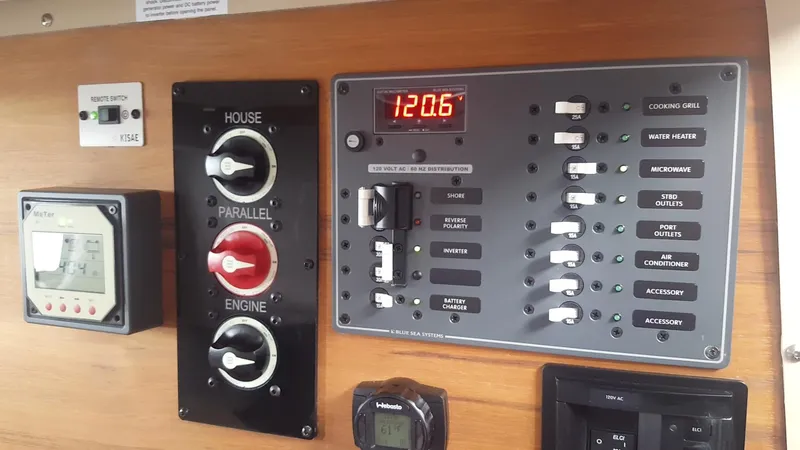 Slide: The Image of Control panel of a 2018 Ranger Tugs R27 OB boat, featuring switches and digital display. - 12