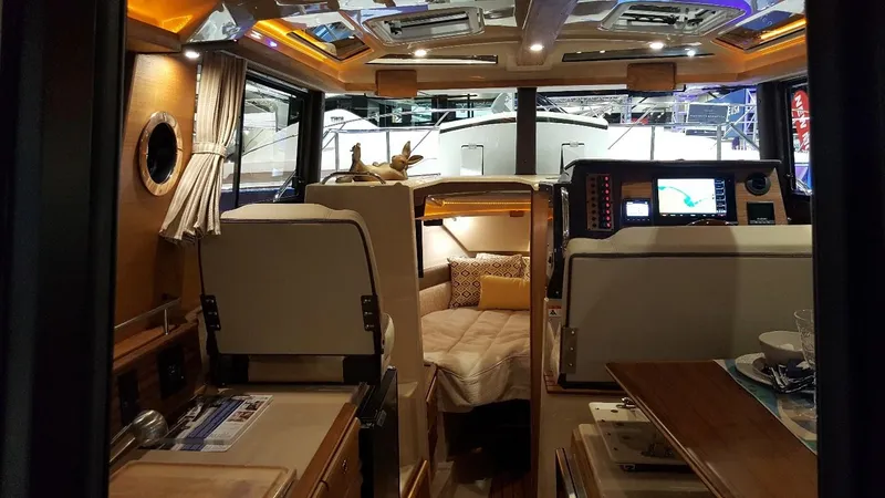 Slide: The Image of 2018 Ranger Tugs R27 OB interior with cozy cabin and modern navigation equipment. - 5