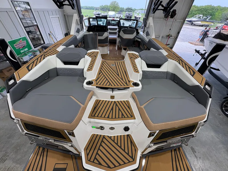 Slide: The Image of 2025 MasterCraft XStar 23 boat interior with gray and white seating, stylish design. - 10